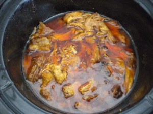 Meat is shreaded and placed back into the slow cooker for further cooking and sauce penetration.